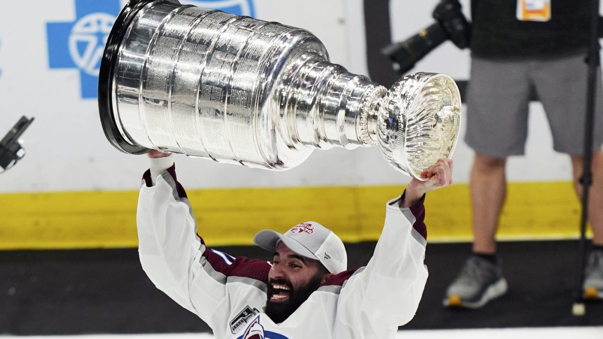 CORRECTS+ID+TO+NAZEM+KADRI+INSTEAD+OF+NATHAN+MACKINNON+-+Colorado+Avalanche+center+Nazem+Kadri+lifts+the+Stanley+Cup+after+the+team+defeated+the+Tampa+Bay+Lightning+2-1+in+Game+6+of+the+NHL+hockey+Stanley+Cup+Finals+on+Sunday%2C+June+26%2C+2022%2C+in+Tampa%2C+Fla.+%28AP+Photo%2FJohn+Bazemore%29