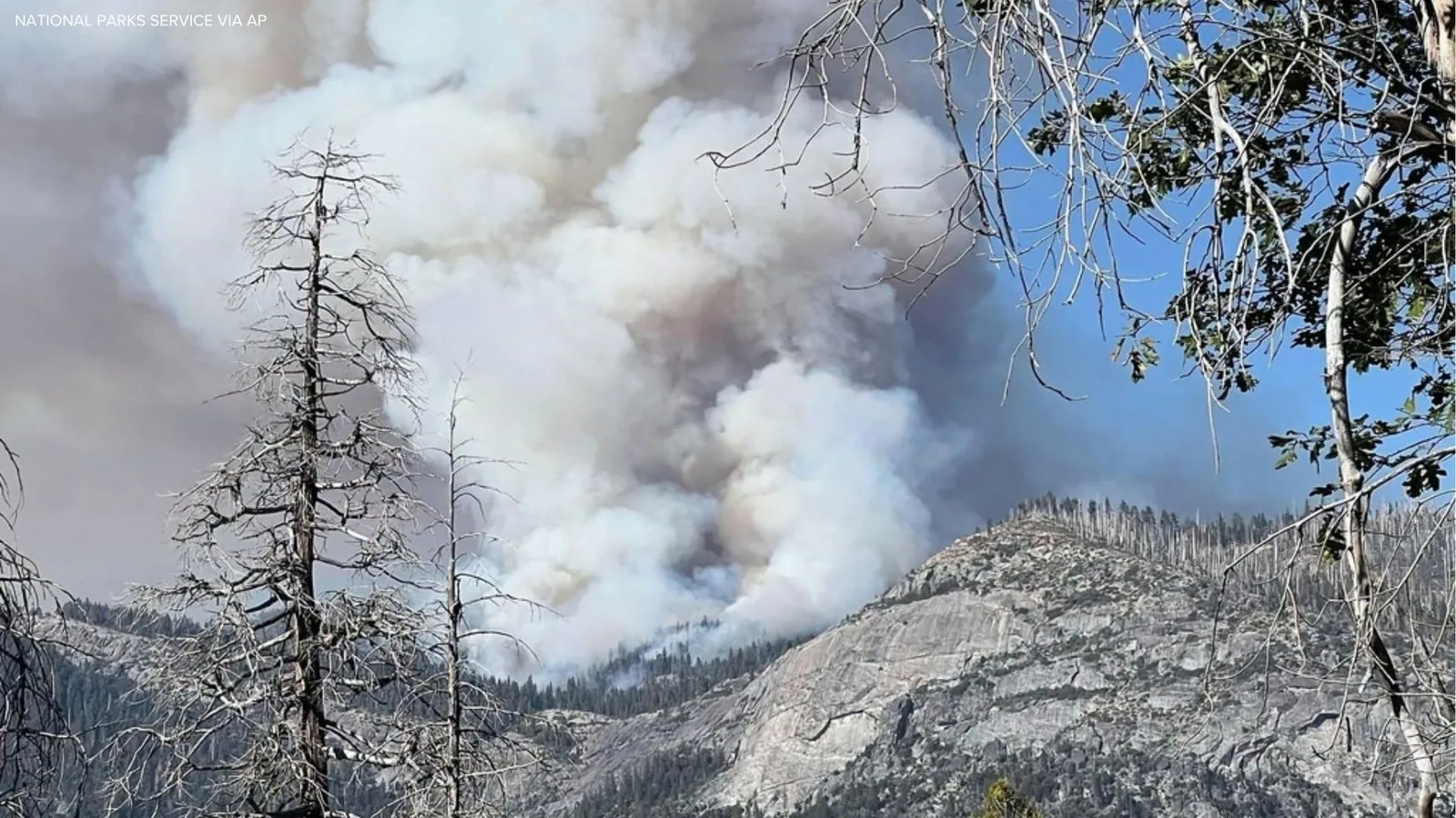 A firefighting helicopter over a wildfire near Yosemite National Park