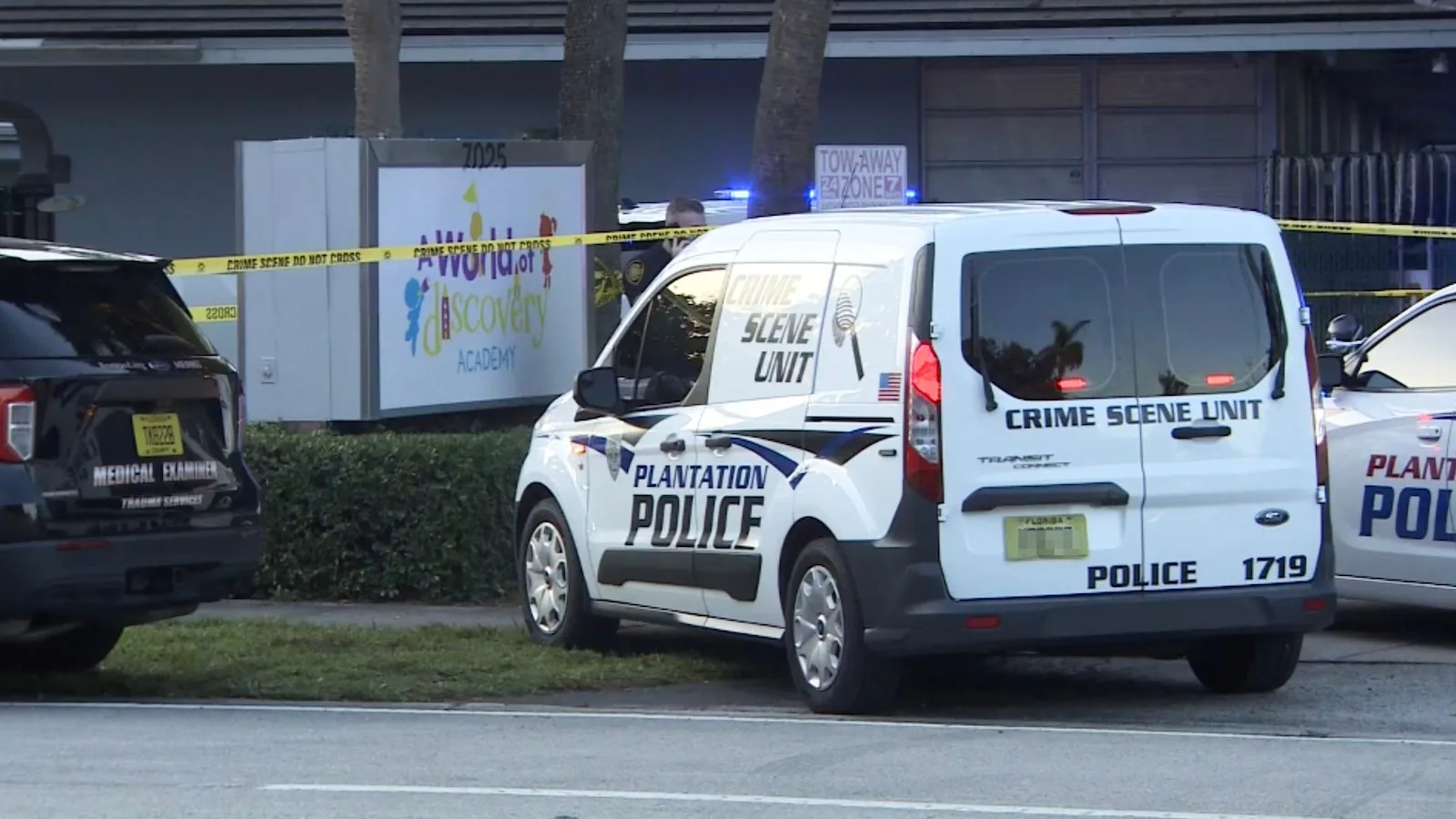 Police and fire crews at a preschool parking lot outside an SUV after a child was found dead inside